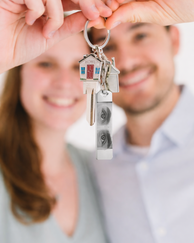 2 couples are holding keychain with engraved eyes from real photo
