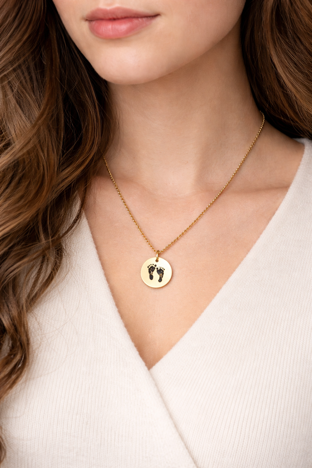Woman wearing custom footprint necklace for newborn