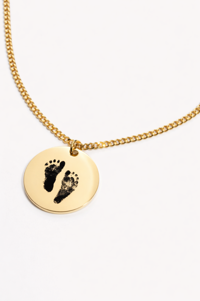 Close-up of engraved baby footprint pendant with name and date, perfect Mother’s Day gift.