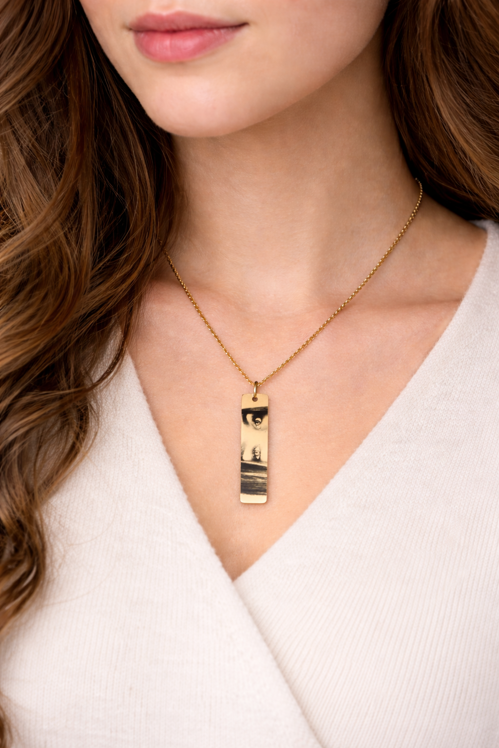 a woman is wearing an engraved necklace with real eyes from real photo