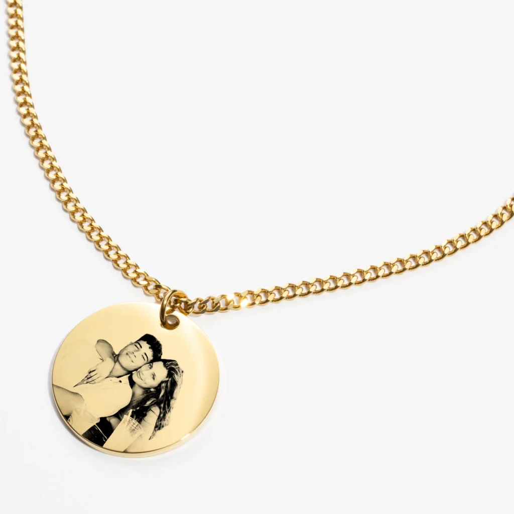 Close-up of custom necklace showing engraving details and chain texture