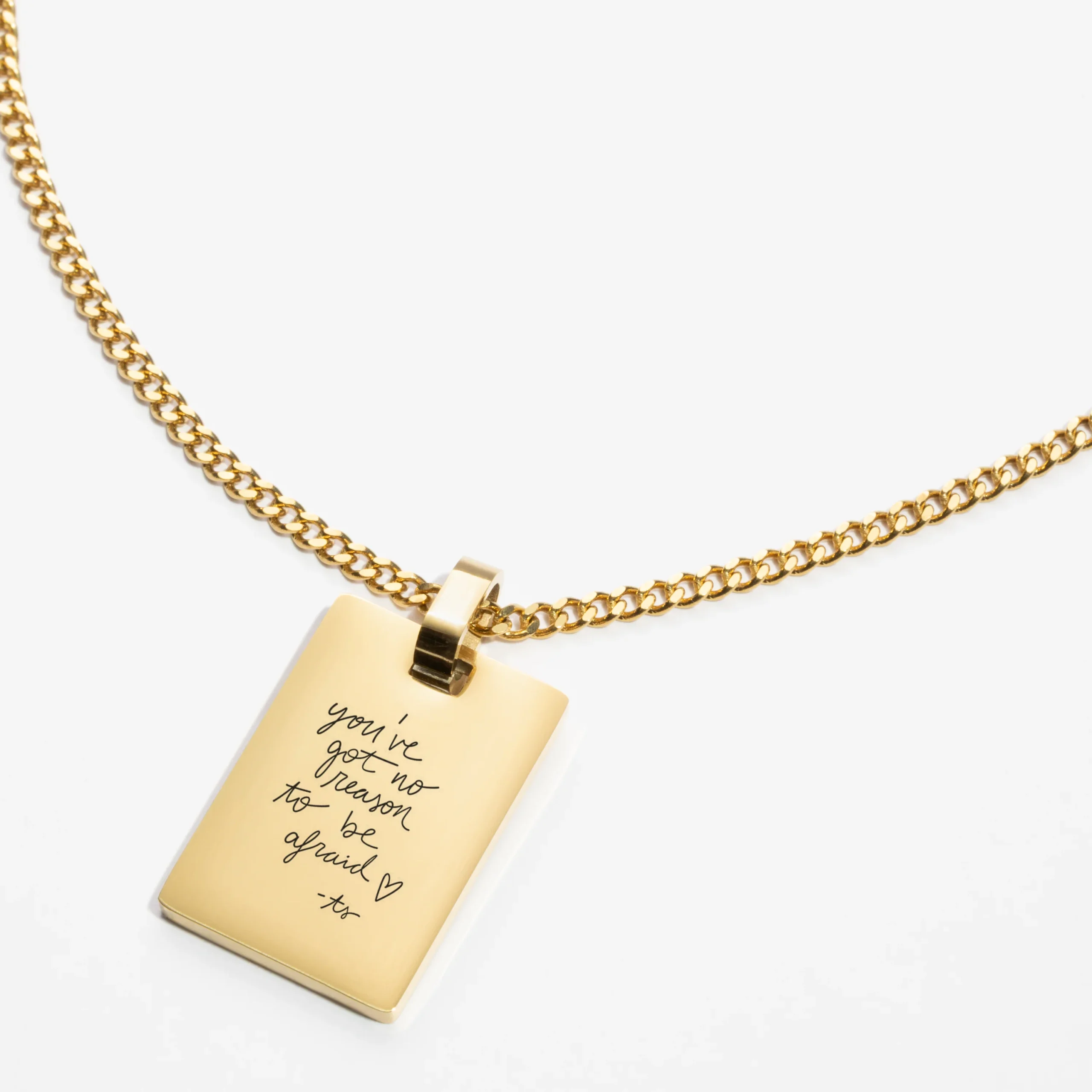 A close-up of a custom necklace featuring intricate handwriting engraving, highlighting its fine details and craftsmanship.