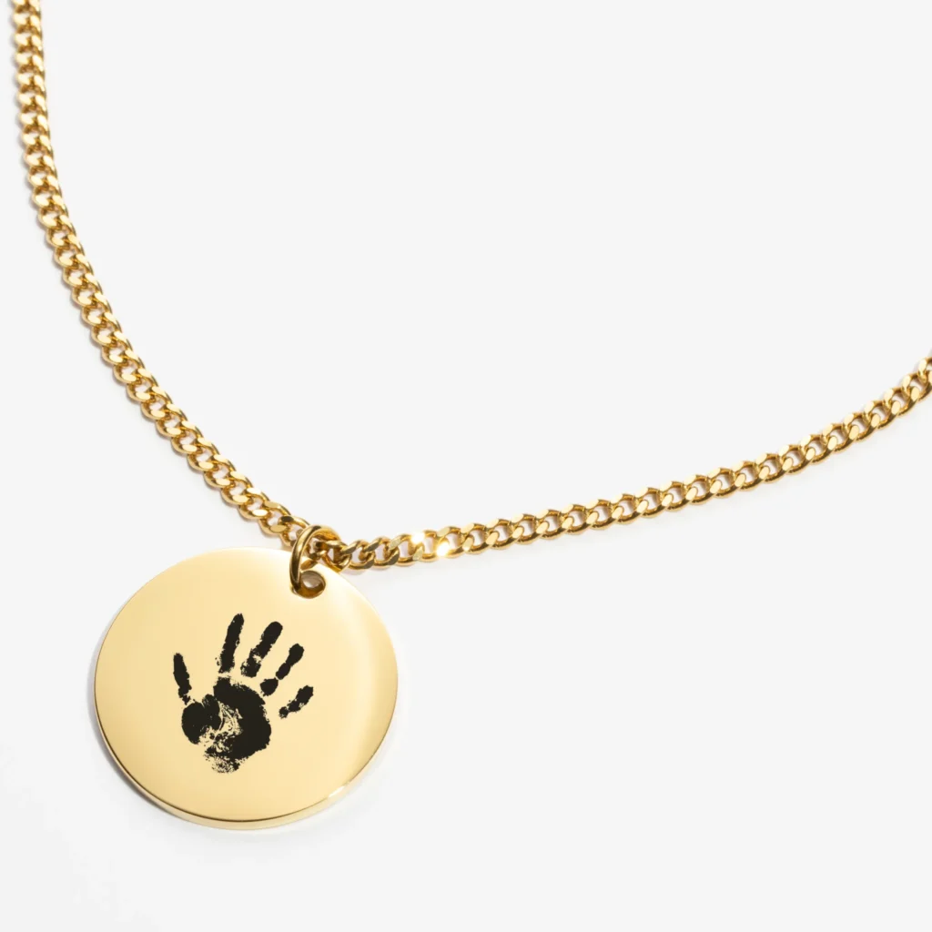 Personalized baby handprint pendant close-up showing engraving details