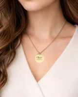 A model wearing a custom necklace with engraved text, showcasing its delicate design and personalized touch.