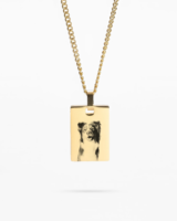 A custom pet photo necklace in gold, showcasing a heartwarming image of your pet."