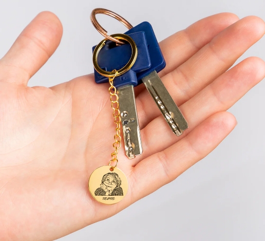 Custom photo keychain featuring engraved human portrait