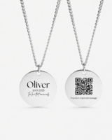 Custom Text Necklace with Hidden QR Code Message: Two silver round pendant necklaces hang against a clean light background. The left pendant is engraved with the name “Oliver,” the date “12.09.2025,” and the phrase “The love that never ends,” while the right pendant features a QR code above the words “Scan for a special message.