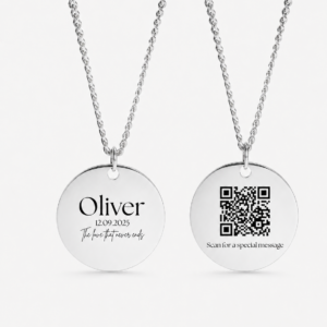 Custom Text Necklace with Hidden QR Code Message: Two silver round pendant necklaces hang against a clean light background. The left pendant is engraved with the name “Oliver,” the date “12.09.2025,” and the phrase “The love that never ends,” while the right pendant features a QR code above the words “Scan for a special message.