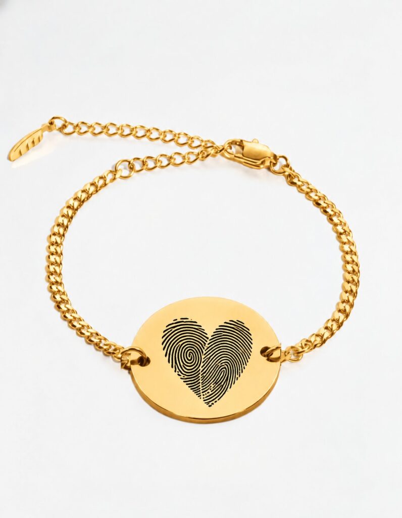 Gold two fingerprint heart bracelet — round disc with two fingerprints engraved as a heart on a gold Cuban chain bracelet. Actual fingerprint bracelet for couples, anniversary keepsake gift in gold plated stainless steel.