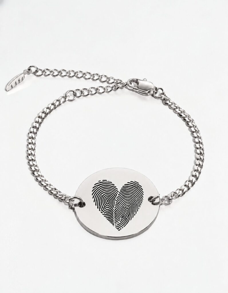Two fingerprint bracelet in silver — two actual fingerprints engraved as a heart on a round disc, Cuban chain bracelet with lobster clasp and extender. Personalized couples fingerprint bracelet in stainless steel.