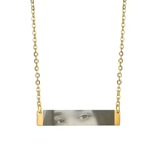 Silver chain necklace with a rectangular pendant displaying a black and white photo of a person’s eyes