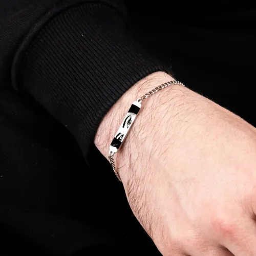 a man is wearing engraved eye bracelet in silver