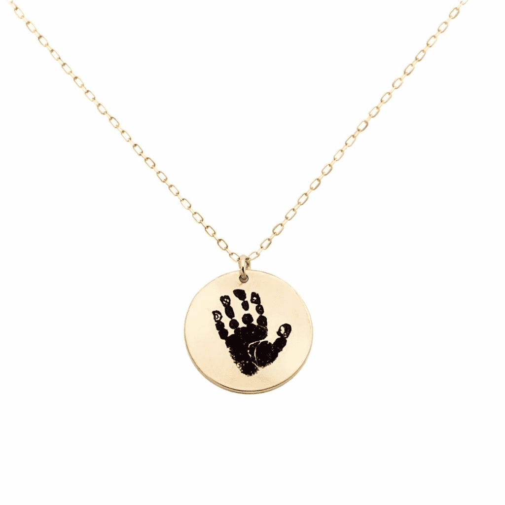 Engraved Baby Handprint Necklace with custom name and birth date.
