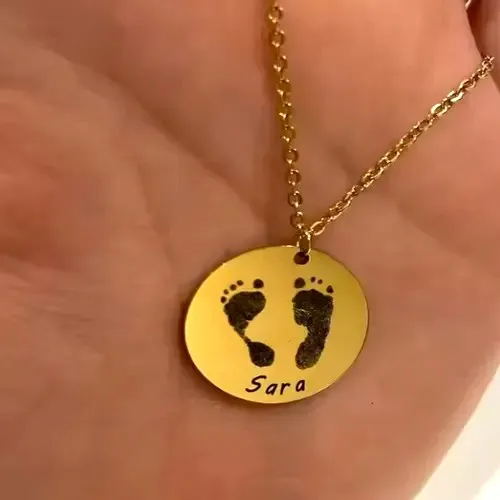 Close-up of engraved baby footprint pendant with name and date, perfect Mother’s Day gift.