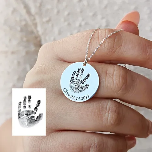 Personalized baby handprint pendant close-up showing engraving details