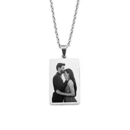 Custom engraved photo necklace in silver with a rectangular pendant featuring a personalized black and white image for couple