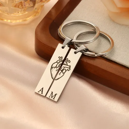 Matching split heart keychains, symbolizing connection and shared memories.